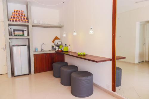 a kitchen with a counter and stools in a room at Hostel Republic at Galle Face in Colombo