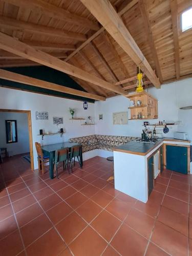 a kitchen with a table and a counter top at Casita - your home in Flores in Lajes das Flores