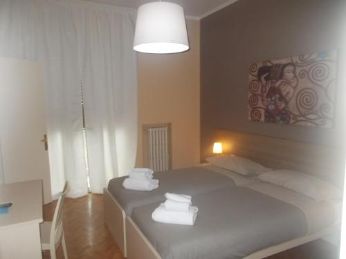 a bedroom with two beds with towels on them at B&B Cameracaffè Centro in Arezzo