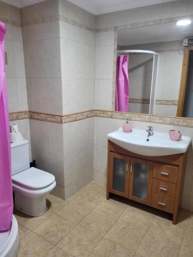 a bathroom with a sink and a toilet and a mirror at carrer de la pau port de sagunto in Valencia