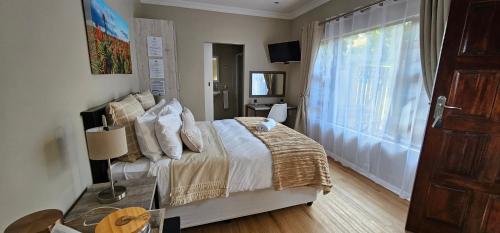 a bedroom with a large bed and a window at Dream Hills in Hillcrest