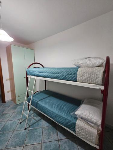 a room with two bunk beds and a cabinet at Casa Li Conchi in Arzachena