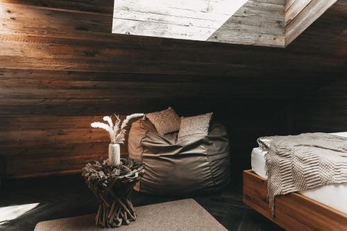 a room with a couch and a table with at Jufenalm BOHO & Wellnesshotel in Maria Alm am Steinernen Meer