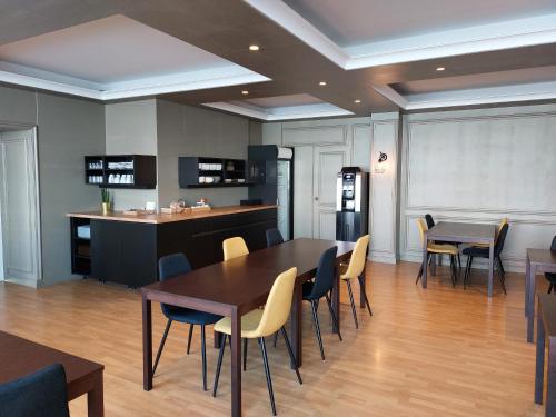 a kitchen and dining room with tables and chairs at Cit'Hôtel l'Europe - Cholet Gare in Cholet