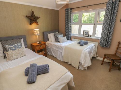 Postel nebo postele na pokoji v ubytování 1 Hornbeam Lodge