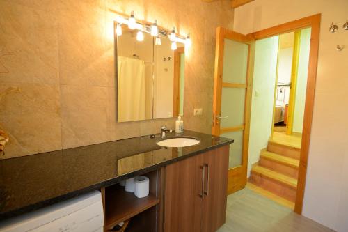 a bathroom with a sink and a mirror at Apartamento en pleno Montseny Mas Romeu Turisme Rural in Arbúcies
