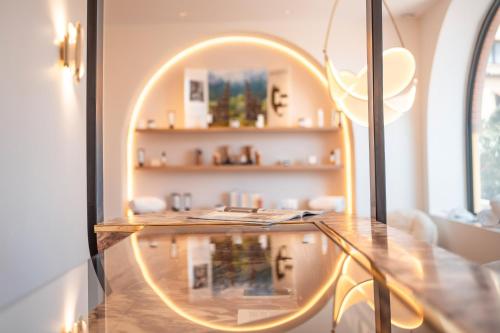 a room with a glass table and a mirror at Ermitage de l'Oasis & Spa - Cannes Mandelieu in Mandelieu-la-Napoule