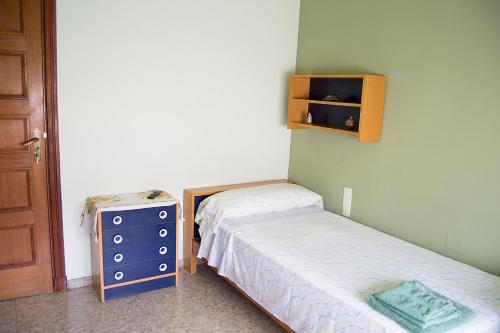 a small bedroom with two beds and a dresser at Habitació V Cal Kim in Martorell