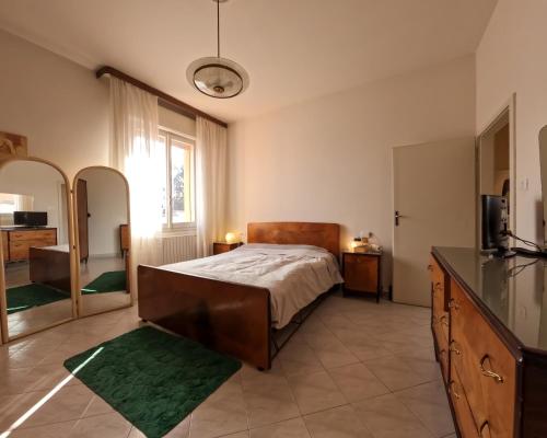 a bedroom with a bed and a tv and a mirror at Spadini Apartment in Bologna