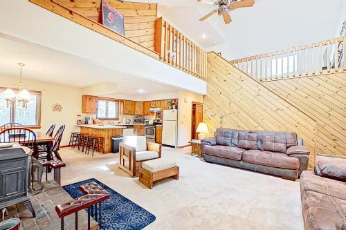 a living room with a couch and a table at White Mountain Hideaway in North Conway