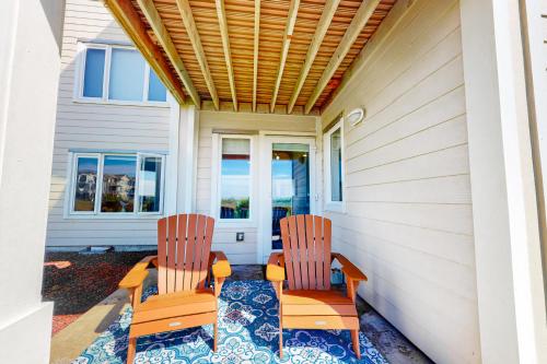 two chairs sitting on the porch of a house at Surf's Up in Westport