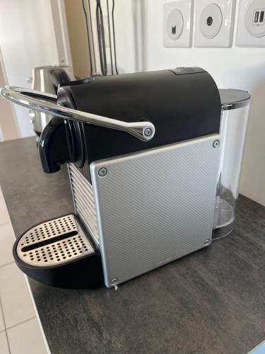 a toaster sitting on top of a kitchen counter at La Maison de Jade & Spa in La Roche-de-Glun