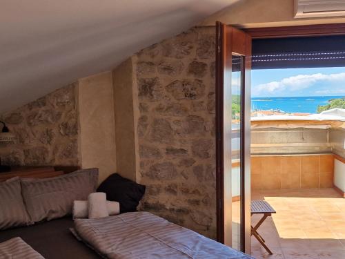 a bedroom with a bed and a view of the ocean at VISTA ART sea view in Funtana