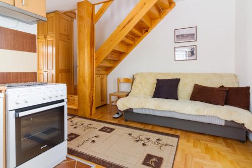 a living room with a couch and a stove at Vila Savinka in Zlatibor