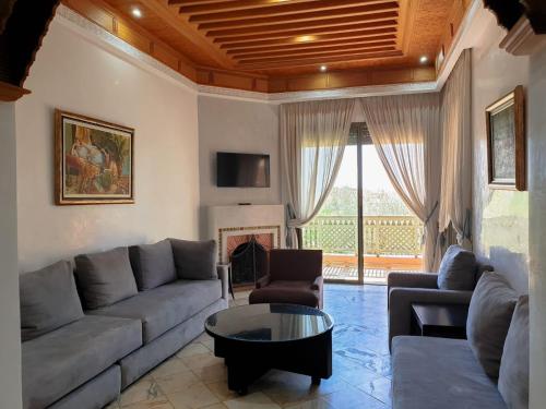 a living room with a couch and a table at palmeraie village 2 in Marrakech