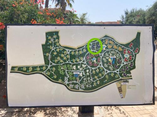 a map of a garden on a sign at palmeraie village 2 in Marrakech