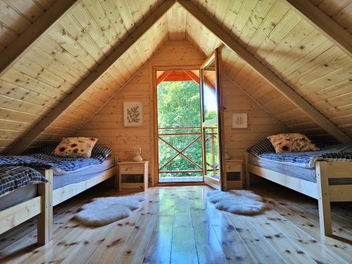 a room with two beds in a attic at Ogród Weigla in Janowice Wielkie