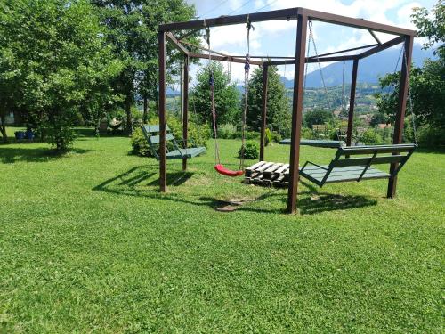 a park with two benches and a swing at Inspire View - Boutique in Bran