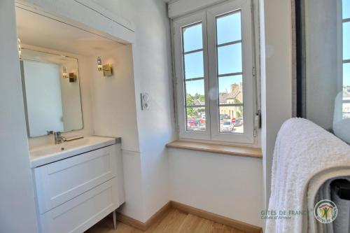 a bathroom with a sink and a window at Le presbytere in Plouaret