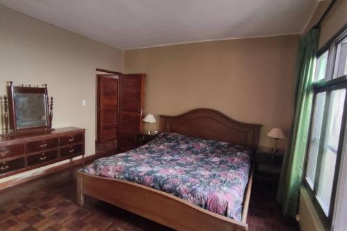 a bedroom with a bed and a flat screen tv at Casa 363/ 2-8 personas in Tarija