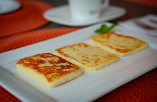 three pieces of food on a white plate on a table at Pousada Xica in Fernando de Noronha