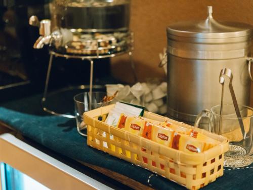 a basket of food on a counter in a kitchen at Showcase Hotel KASANE in Gotsu