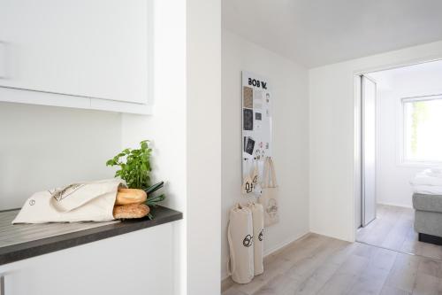 a kitchen with white walls and a counter with vegetables on it at Bob W Gamle Oslo in Oslo