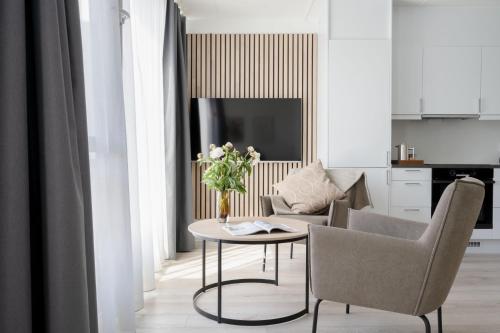 a living room with a table and a couch at Bob W Oslo Gamle in Oslo