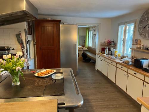a kitchen with a refrigerator and a table with a plate of food at Frühstückspension Gsenger in Ramsau am Dachstein