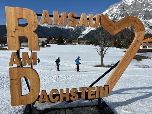 a large sign that says amazon amsterdam in the snow at Frühstückspension Gsenger in Ramsau am Dachstein