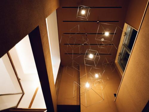a hallway with lights on the wall at Showcase Hotel KASANE in Gotsu