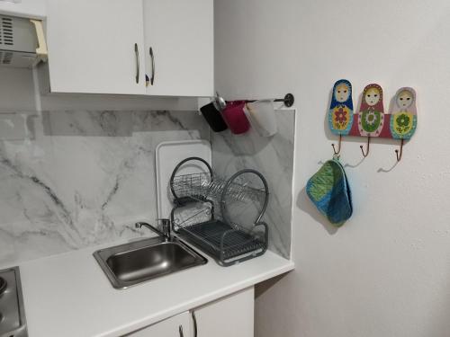 uma cozinha com um lavatório e uma bancada em Aconchego do Lar no Gerês