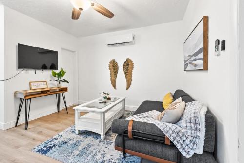 a living room with a couch and a table at Intimate Casita Mia minutes away from Airport, Calle 8, Brickell, Coral Gables, The beach and more! in Miami