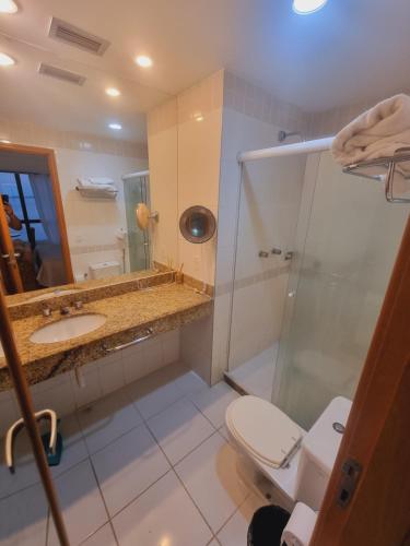 a bathroom with a shower and a toilet and a sink at Tropical Executive Vista Ponta Negra in Manaus