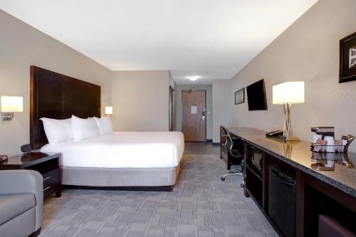 a hotel room with a bed and a desk at Days Inn by Wyndham Medicine Hat in Medicine Hat