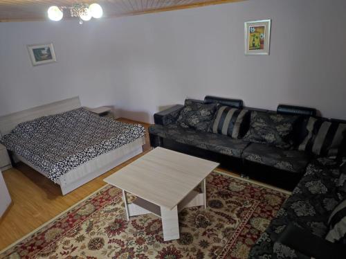 a living room with a couch and a coffee table at Осенний Звездопад in Cholpon-Ata