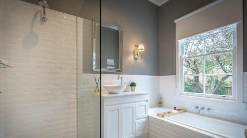 a bathroom with a shower and a sink and a tub at Soma Trentham in Trentham