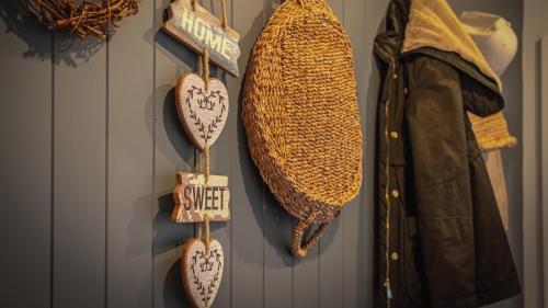 a wall with a bunch of hats and hearts on a wall at Soma Trentham in Trentham