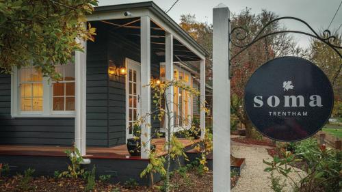 a tiny house with a sign in front of it at Soma Trentham in Trentham