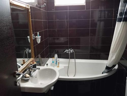 a bathroom with a sink and a tub with a shower at The Genius apartment 3 rooms, Α floor 3 υπνοδωμάτια, A όροφος in Athens