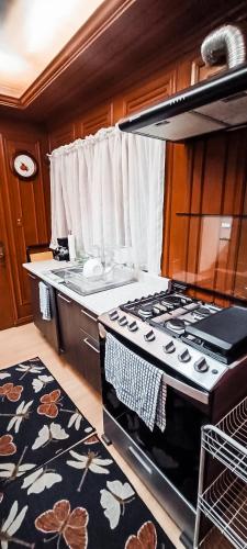 a kitchen with a stove and a counter top at C.-Habitación con baño privado / Centro de Coyoacan in Mexico City
