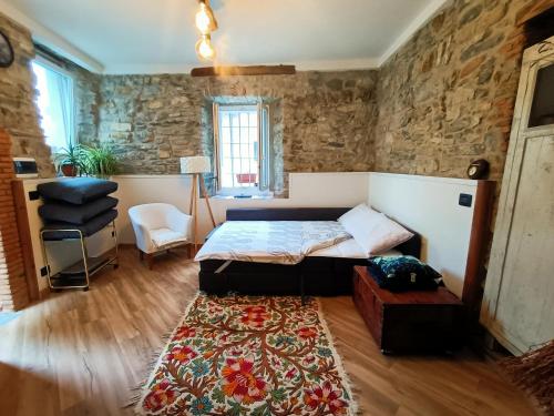 a bedroom with a bed and a rug at casa Virginia nel borgo in Lierna