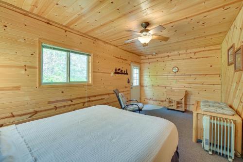 a log cabin bedroom with a bed and a window at Woodland Cabin with Fishing, ATV and Snowmobile Trails in Lake Nebagamon