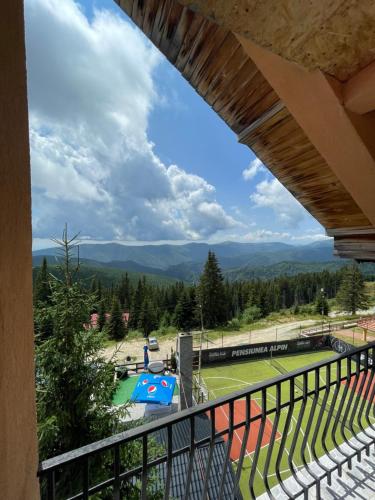 a view of a tennis court from a balcony at Casa de vacanta trei brazi in Ranca