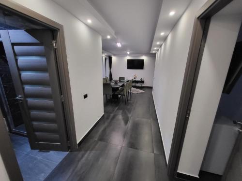 a hallway leading to a dining room with a table at White Story in Brezoi