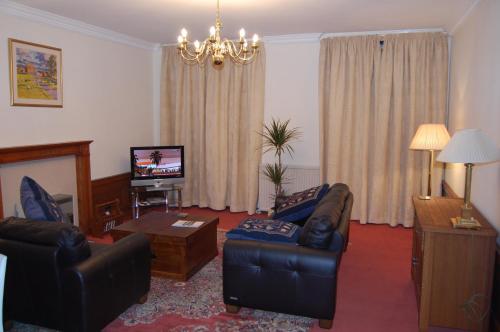a living room with two couches and a tv at Royal Mile Blair in Edinburgh