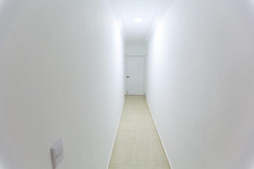 an empty hallway with white walls and a floor at MB Apartment - A in San Felipe de Puerto Plata