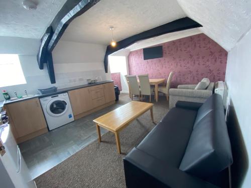a living room with a couch and a table at Spacious One Bedroom Flat with River View, 1E in Great Yarmouth