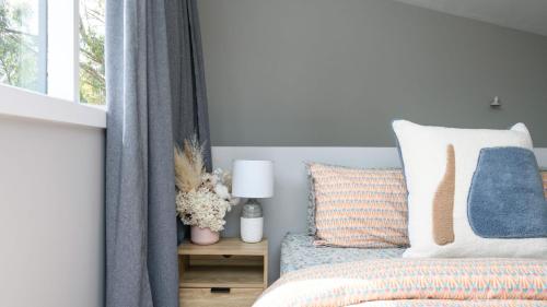 a bedroom with a bed and a window at Wyuna Hepburn Springs in Hepburn Springs