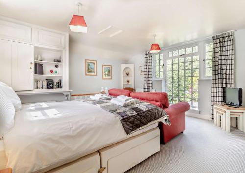 a bedroom with a large bed and a tv at Coach House Cottage Annexe in Wickham Market